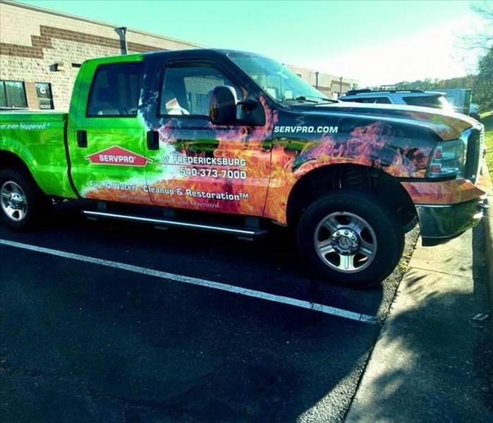 SERVPRO of Fredericksburg multicolor orange and green flame truck
